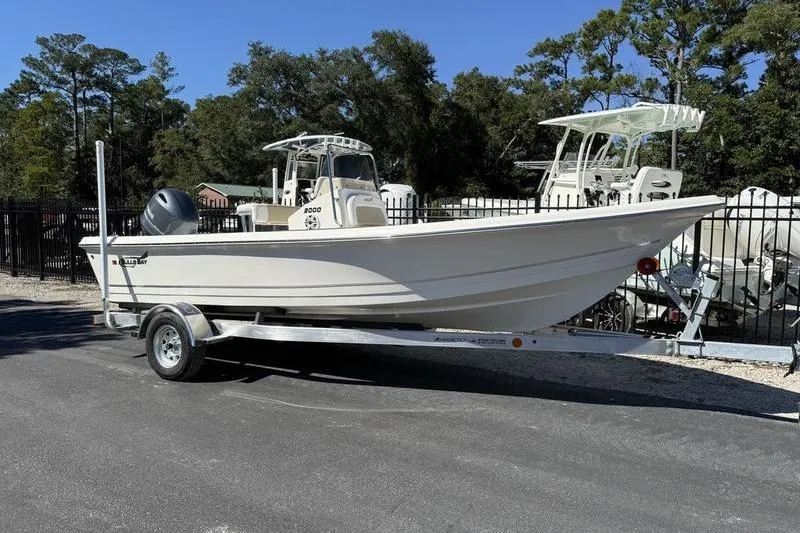 Slide: The Image of 2026 Bulls Bay 2000 boat on trailer, parked outdoors with trees in background. - 0