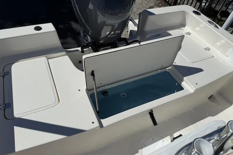 Slide: The Image of 2026 Bulls Bay 2000 boat interior with open storage compartment and motor. - 10