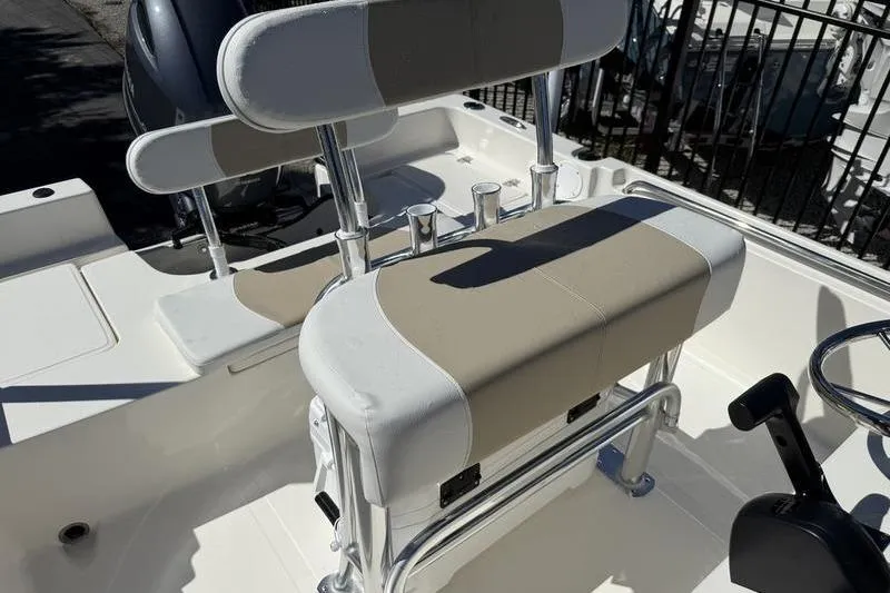 Slide: The Image of 2026 Bulls Bay 2000 boat interior with cushioned seating and rod holders. - 12