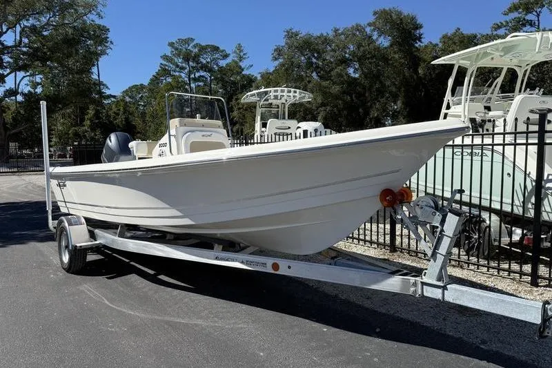 Slide: The Image of 2026 Bulls Bay 2000 boat on trailer, parked outdoors near other boats. - 3