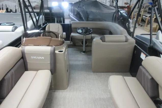 The Image of 2026 Sylvan 818 Mirage Cruise interior with beige seating and modern design. - 2