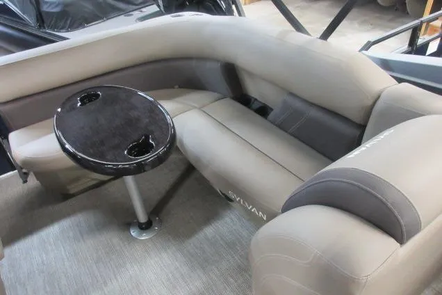 Slide: The Image of 2026 Sylvan 818 Mirage Cruise boat interior with plush seating and a round table. - 5