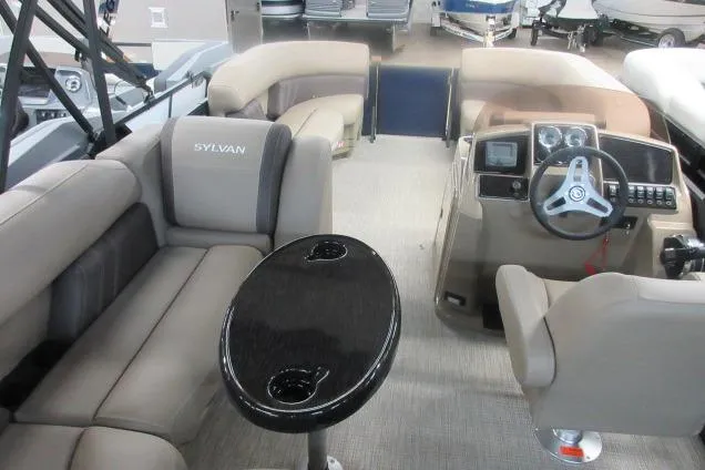 Slide: The Image of 2026 Sylvan 818 Mirage Cruise boat interior with plush seating and modern dashboard. - 8