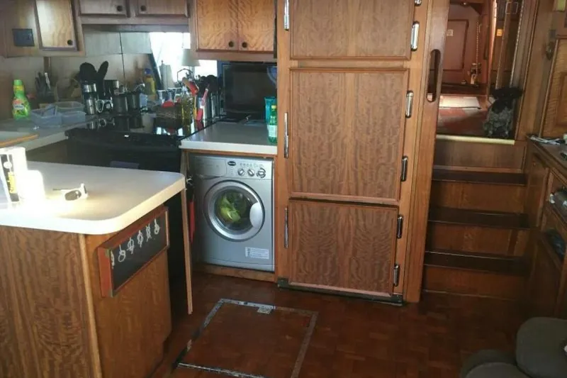 Slide: The Image of 1977 Hatteras 48 Long Range Cruiser kitchen with wood cabinetry and compact appliances. - 10