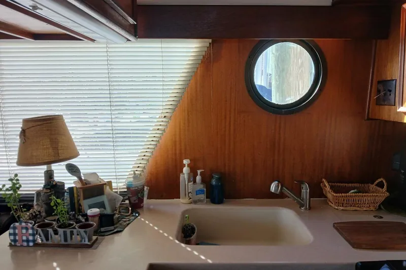 Slide: The Image of Interior of 1977 Hatteras 48 Long Range Cruiser with porthole and kitchen sink. - 16