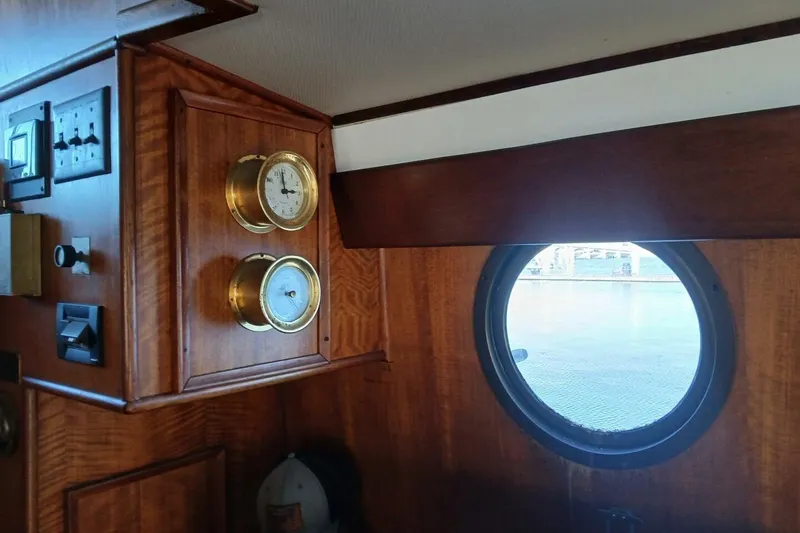 Slide: The Image of Interior of 1977 Hatteras 48 Long Range Cruiser with porthole and brass instruments. - 17