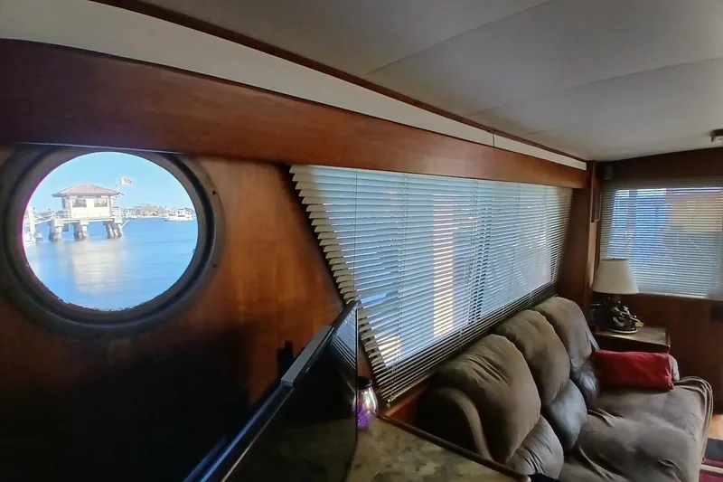 Slide: The Image of Interior of 1977 Hatteras 48 Long Range Cruiser with porthole and cozy seating area. - 18