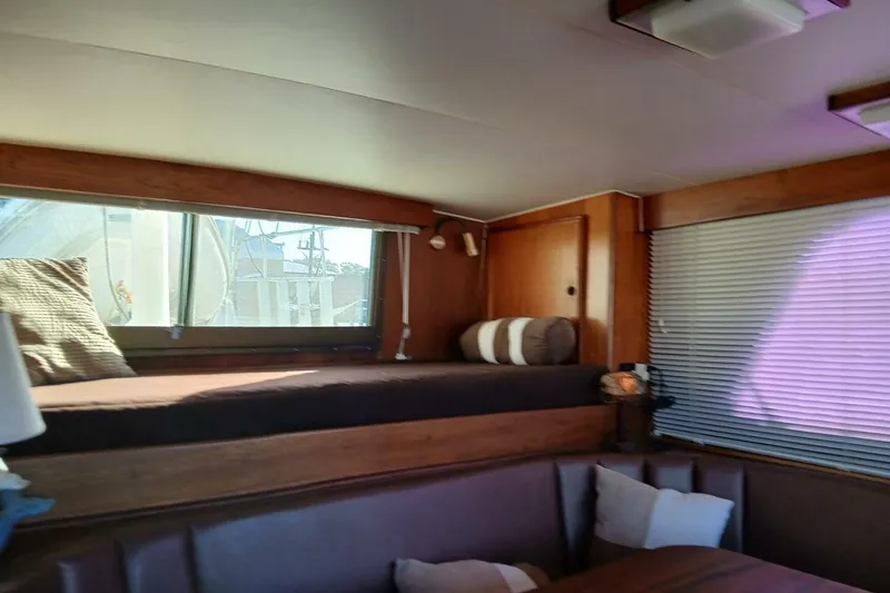 Slide: The Image of Interior of 1977 Hatteras 48 Long Range Cruiser with cozy seating and window view. - 20