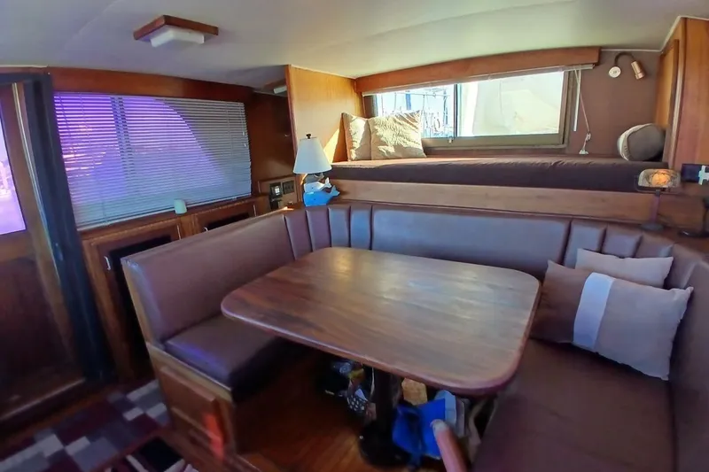 Slide: The Image of Interior of 1977 Hatteras 48 Long Range Cruiser with cozy dining area and seating. - 21