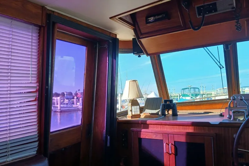 Slide: The Image of Interior view of 1977 Hatteras 48 Long Range Cruiser with marina in background. - 24