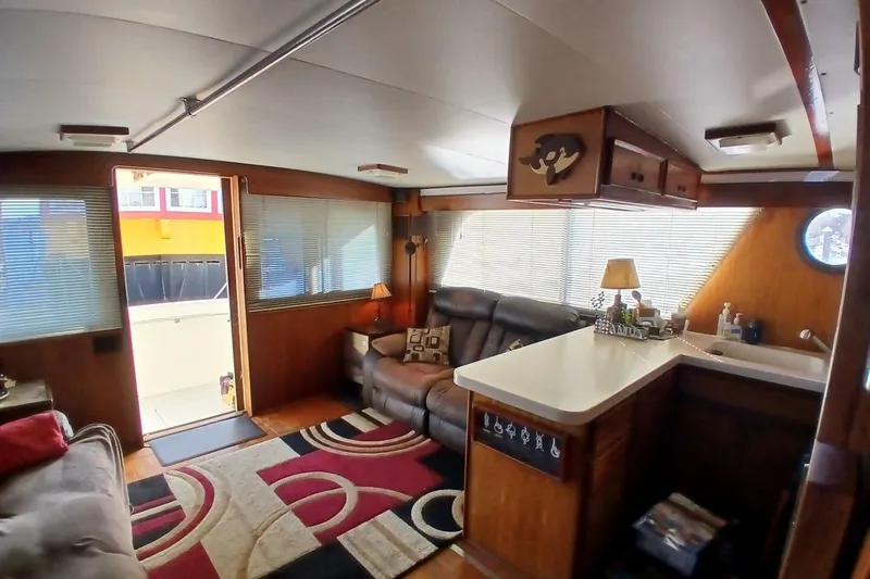 Slide: The Image of Interior of 1977 Hatteras 48 Long Range Cruiser with cozy seating and nautical decor. - 3