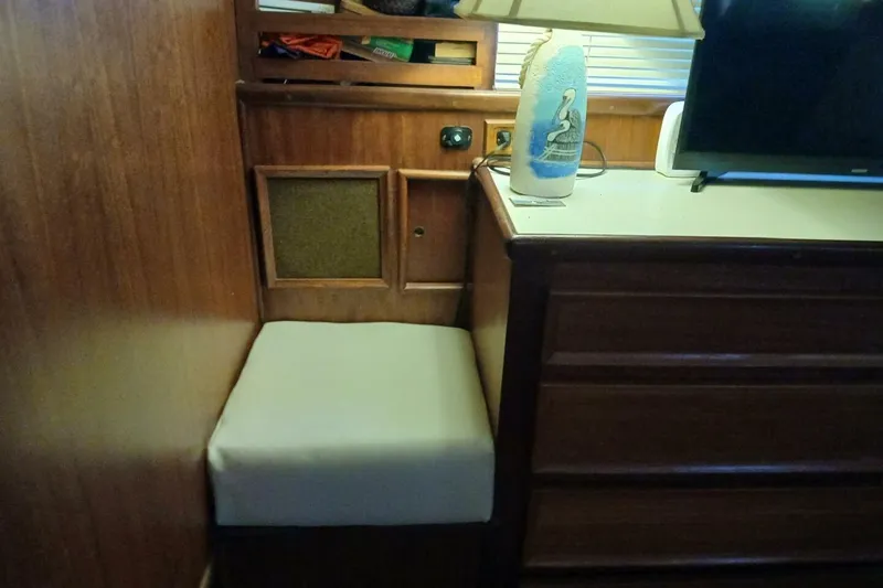Slide: The Image of 1977 Hatteras 48 Long Range Cruiser interior with wooden cabinetry and cushioned seating. - 33