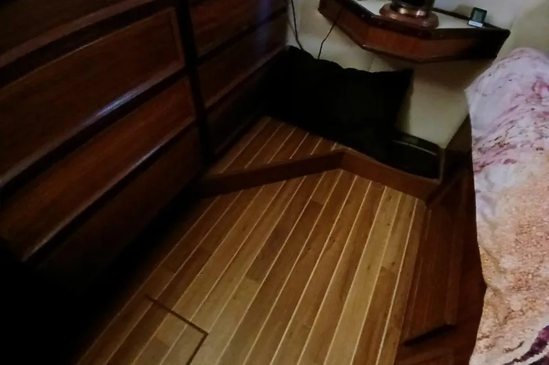 Slide: The Image of Interior of 1977 Hatteras 48 Long Range Cruiser with wooden flooring and cabinetry. - 34