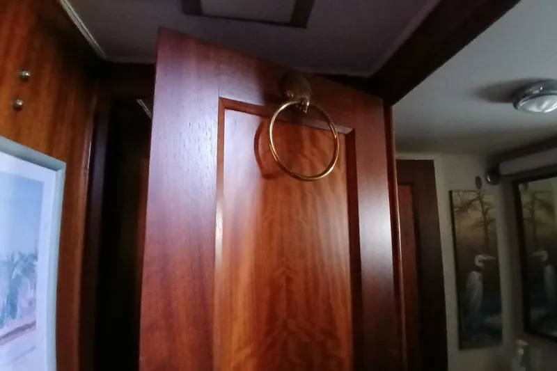 Slide: The Image of Interior of 1977 Hatteras 48 Long Range Cruiser with wooden door and brass handle. - 40
