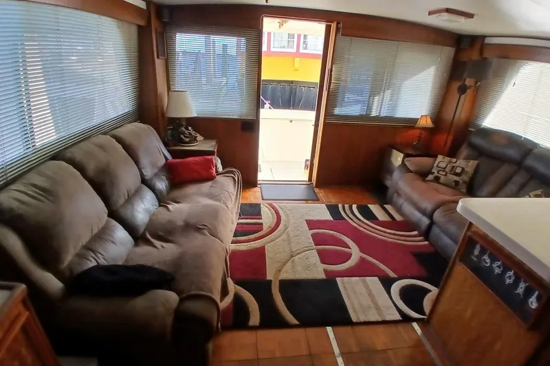 Slide: The Image of Interior of 1977 Hatteras 48 Long Range Cruiser with cozy seating and decorative rug. - 5