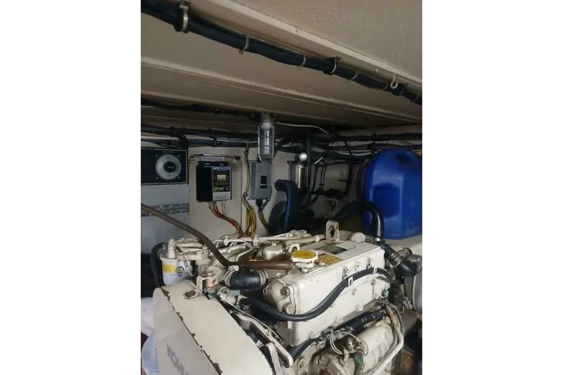 Slide: The Image of Engine room of 1977 Hatteras 48 Long Range Cruiser with visible machinery and wiring. - 63