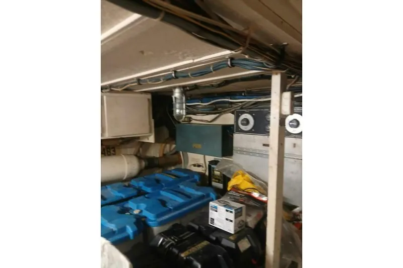 Slide: The Image of Engine room of 1977 Hatteras 48 Long Range Cruiser with equipment and storage. - 64