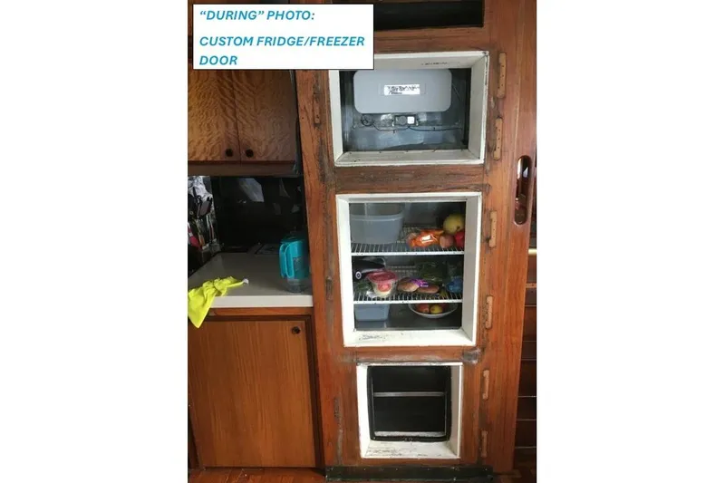 Slide: The Image of 1977 Hatteras 48 Long Range Cruiser custom fridge/freezer door with wooden finish. - 67