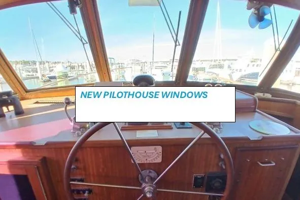 Slide: The Image of 1977 Hatteras 48 Long Range Cruiser pilothouse with new windows and classic wooden steering wheel. - 71