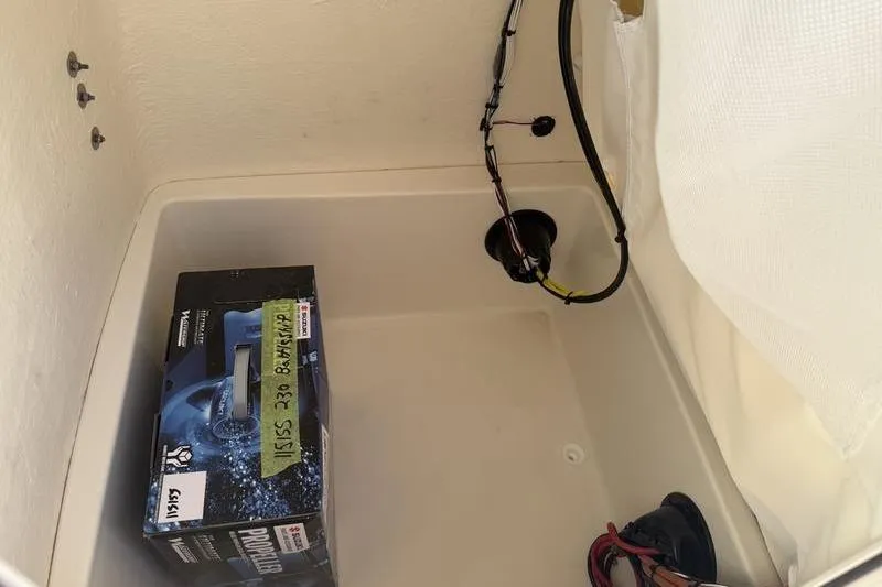 Slide: The Image of 2025 Bulls Bay 230 Center Console storage compartment with wiring and a propeller box. - 15