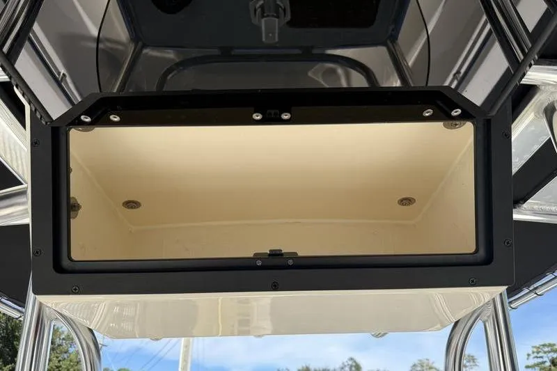 Slide: The Image of 2025 Bulls Bay 230 Center Console storage compartment, open view, showcasing interior space. - 16