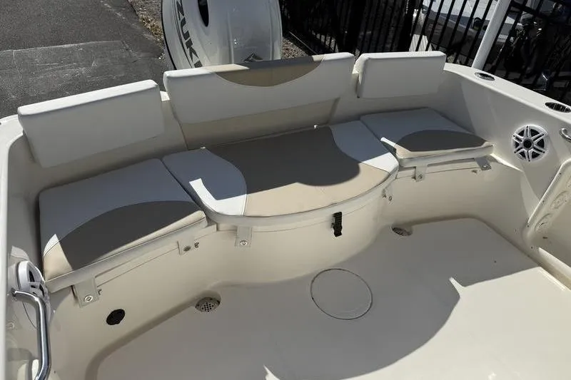 Slide: The Image of 2025 Bulls Bay 230 Center Console boat interior with cushioned seating and storage. - 17