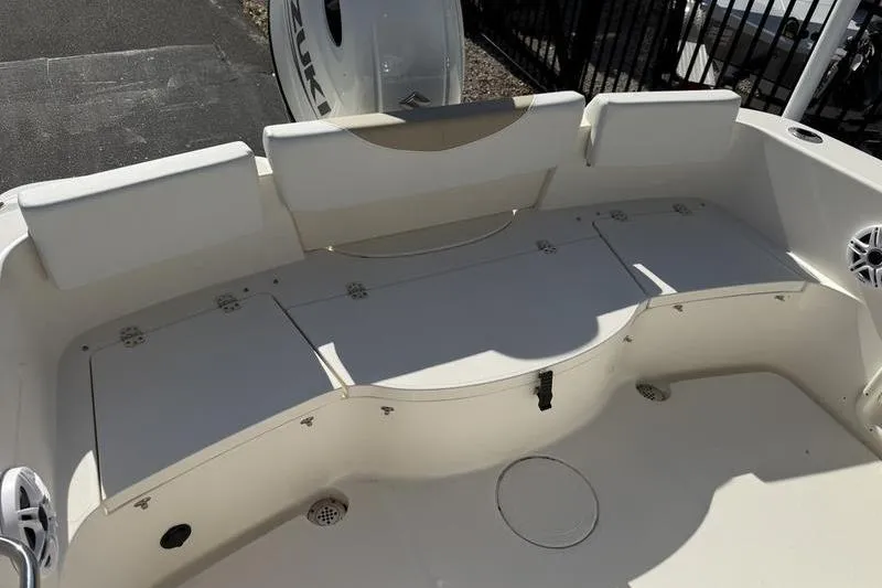 Slide: The Image of 2025 Bulls Bay 230 Center Console boat interior with seating and storage compartments. - 18