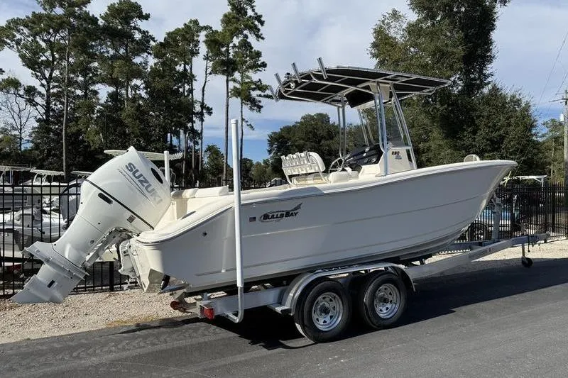 Slide: The Image of 2025 Bulls Bay 230 Center Console boat on trailer with Suzuki outboard motor. - 2