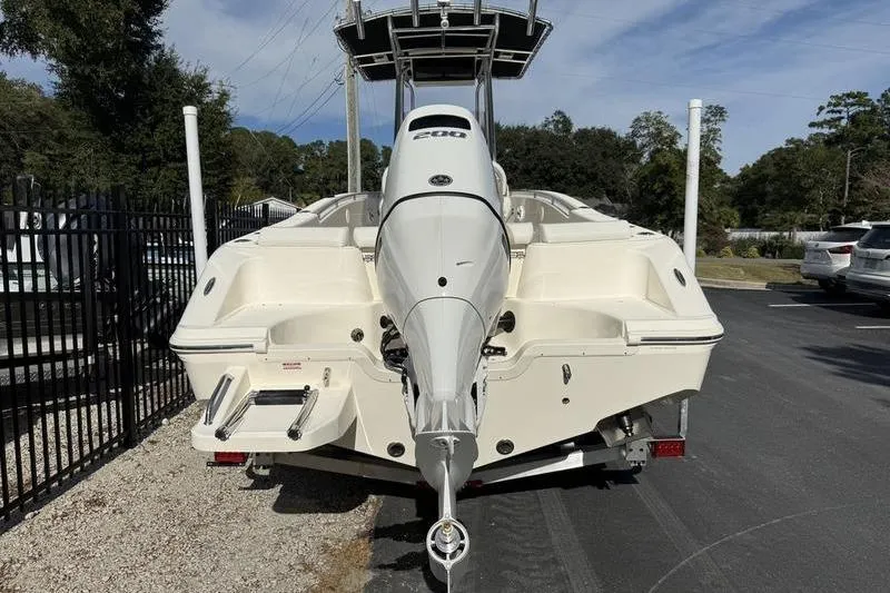 Slide: The Image of 2025 Bulls Bay 230 Center Console boat with powerful outboard motor, parked outdoors. - 5