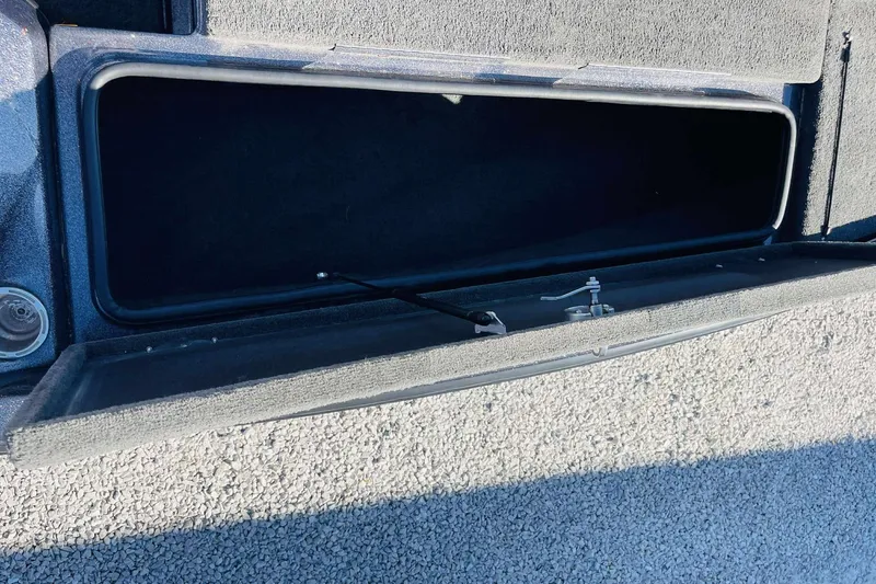 Slide: The Image of Open storage compartment in a 2014 Bass Cat Eyra boat. - 13
