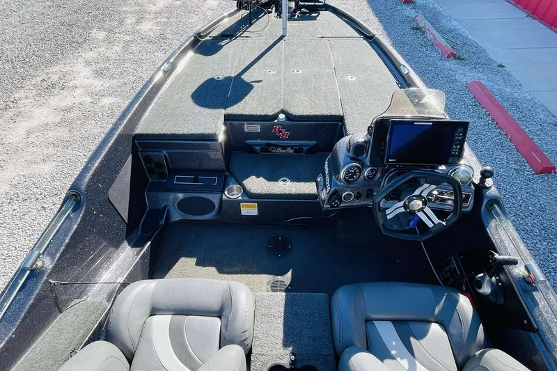 Slide: The Image of 2014 Bass Cat Eyra boat interior with steering console and seating. - 14