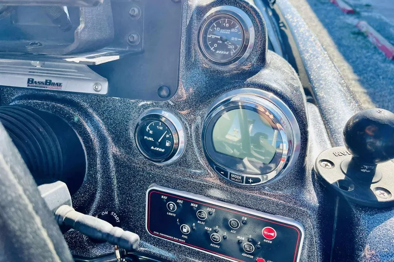 Slide: The Image of Dashboard of a 2014 Bass Cat Eyra boat with gauges and controls. - 17