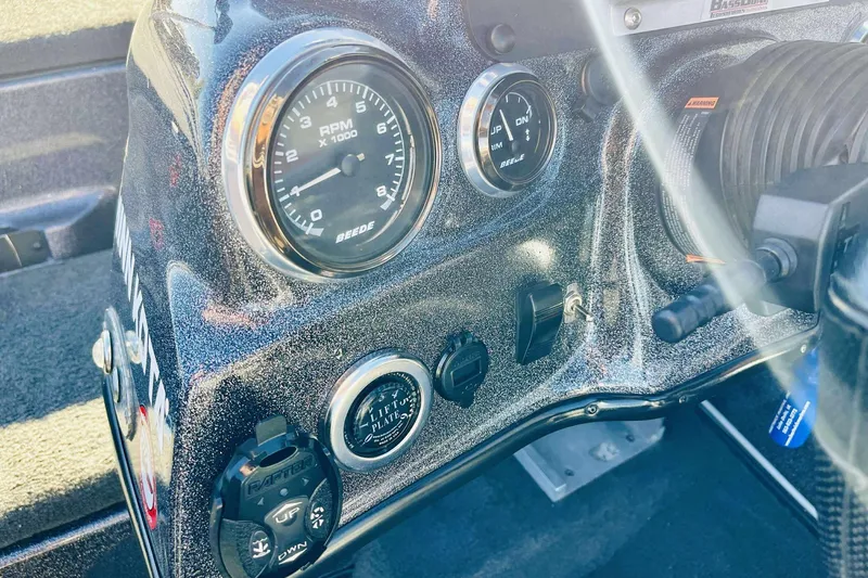 Slide: The Image of Dashboard of a 2014 Bass Cat Eyra boat with RPM gauge and controls. - 18