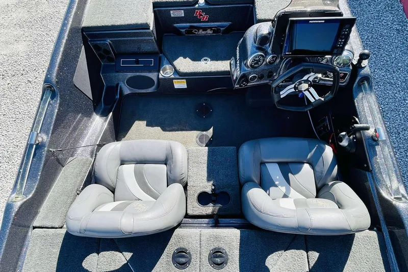 Slide: The Image of 2014 Bass Cat Eyra boat interior with dual seats and steering console. - 22