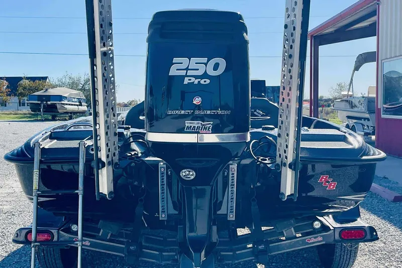 Slide: The Image of 2014 Bass Cat Eyra boat with 250 Pro engine, parked outdoors. - 24