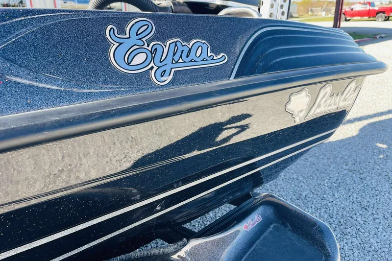 Slide: The Image of 2014 Bass Cat Eyra boat with sleek design and logo detail. - 5