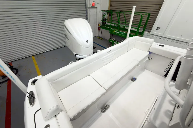 Slide: The Image of 2026 Tidewater 232 LXF boat interior with white seating and Yamaha engine. - 11
