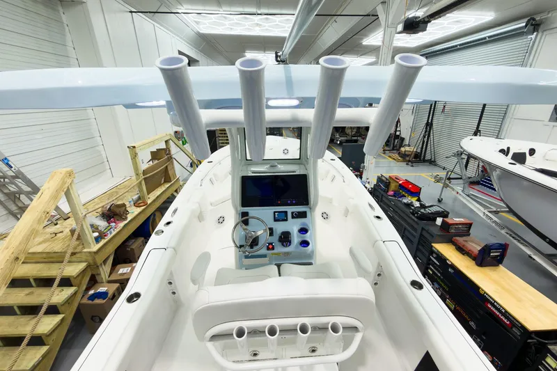 Slide: The Image of 2026 Tidewater 232 LXF boat interior in a workshop setting. - 14
