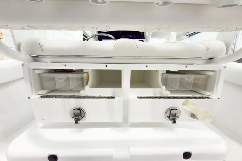 Slide: The Image of 2026 Tidewater 232 LXF boat interior storage compartments with white seating. - 18