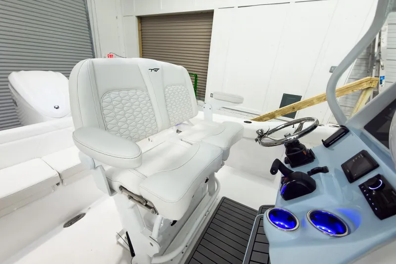 Slide: The Image of 2026 Tidewater 232 LXF boat interior with white seating and modern dashboard controls. - 19