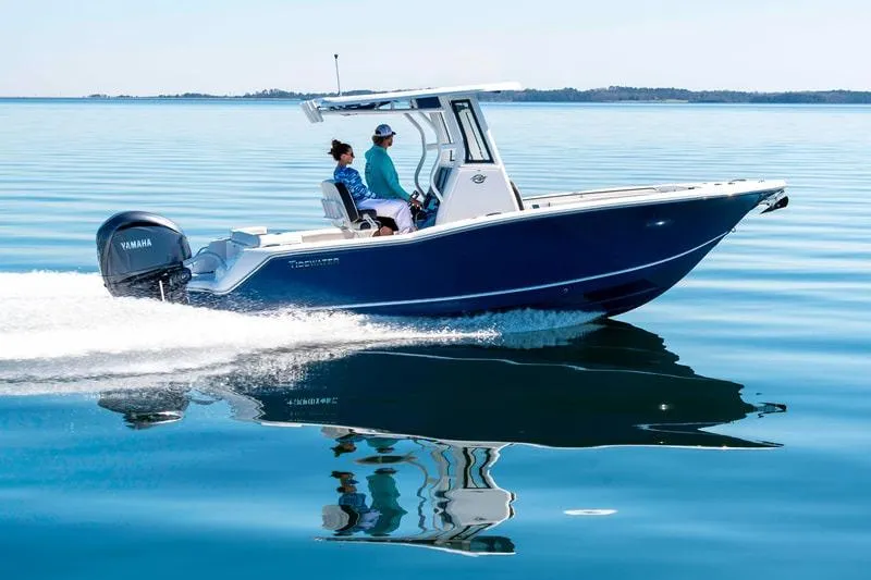 Slide: The Image of 2026 Tidewater 232 LXF boat with Yamaha engine in a showroom. - 2