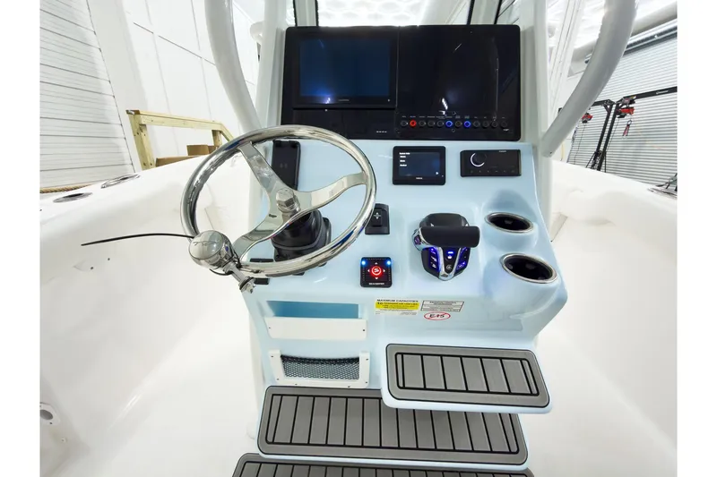 Slide: The Image of 2026 Tidewater 232 LXF boat console with steering wheel and modern controls. - 21