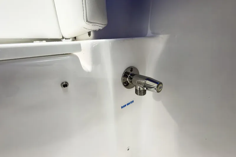 Slide: The Image of Raw water outlet on 2026 Tidewater 232 LXF boat, featuring sleek chrome finish. - 24
