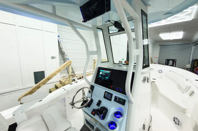 Slide: The Image of 2026 Tidewater 232 LXF boat interior with modern dashboard and steering wheel. - 27