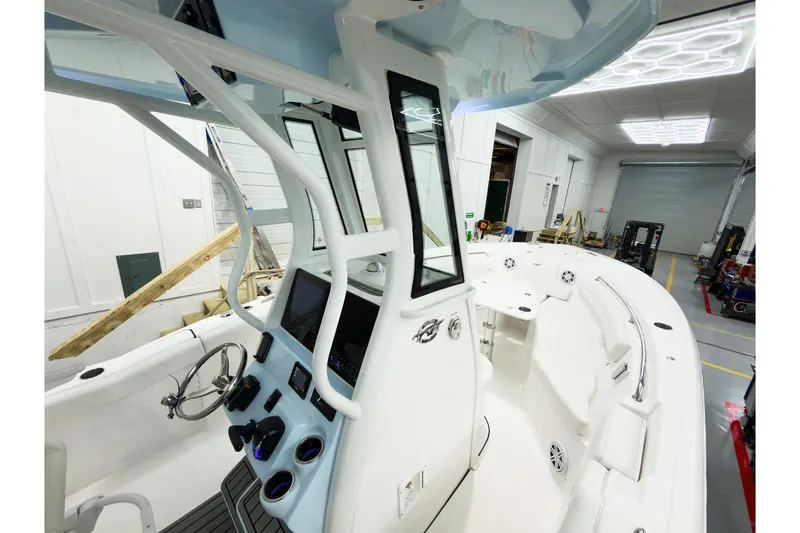 Slide: The Image of 2026 Tidewater 232 LXF boat interior with modern helm and spacious seating. - 31