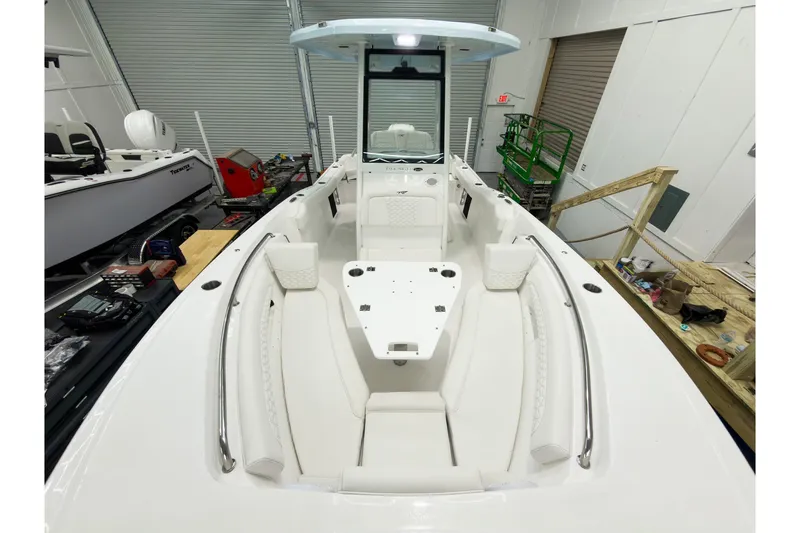 Slide: The Image of 2026 Tidewater 232 LXF boat interior with white seating and center console. - 34