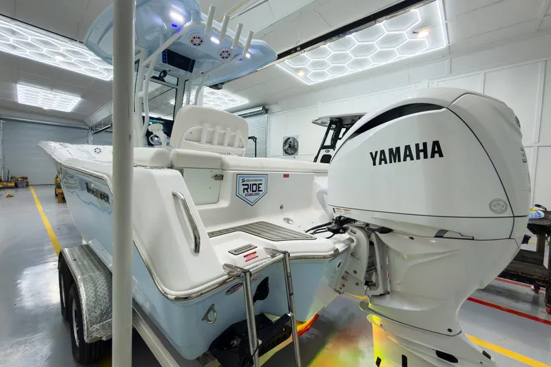 Slide: The Image of 2026 Tidewater 232 LXF boat with Yamaha engine in a modern garage. - 4