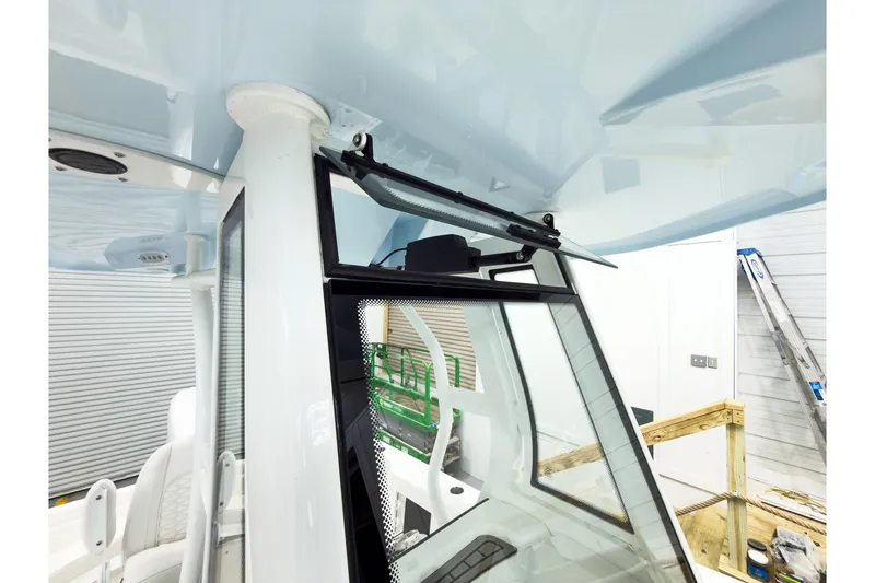 Slide: The Image of 2026 Tidewater 232 LXF boat interior, featuring windshield and seating details. - 41