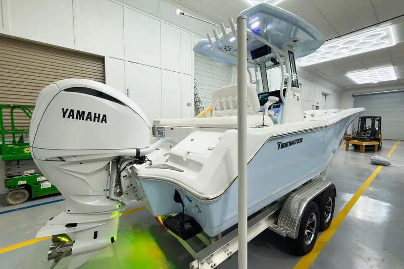 Slide: The Image of 2026 Tidewater 232 LXF boat with Yamaha engine in a showroom setting. - 5