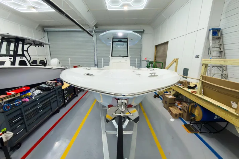 Slide: The Image of 2026 Tidewater 232 LXF boat in a workshop, showcasing sleek design and modern features. - 6